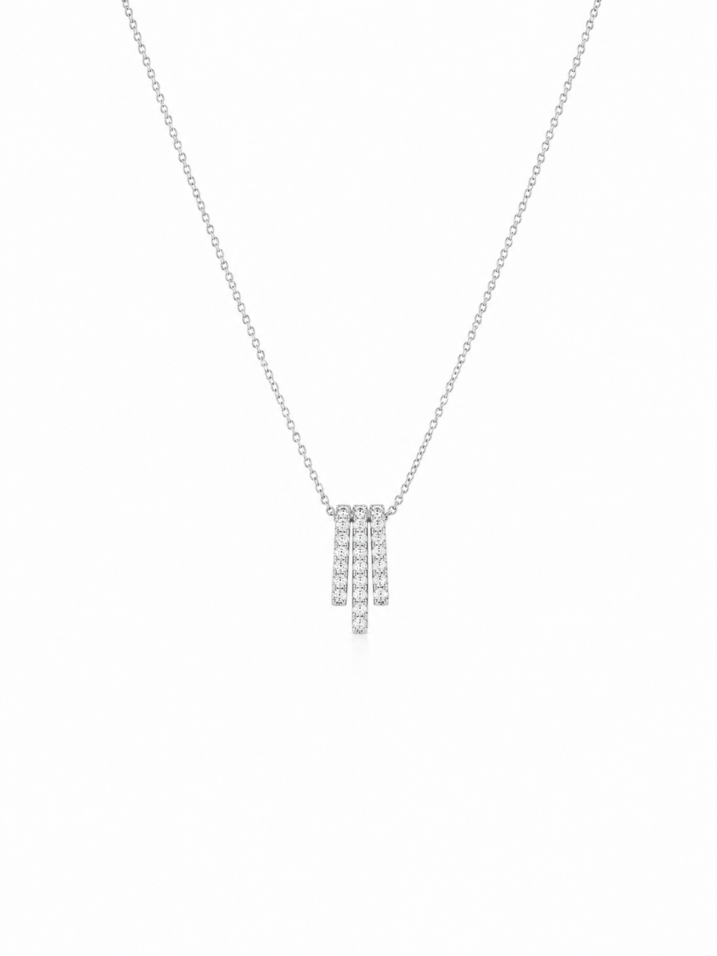 A delicate silver-toned chain necklace with a small geometric pendant set with clear stones, displayed against a solid white background.