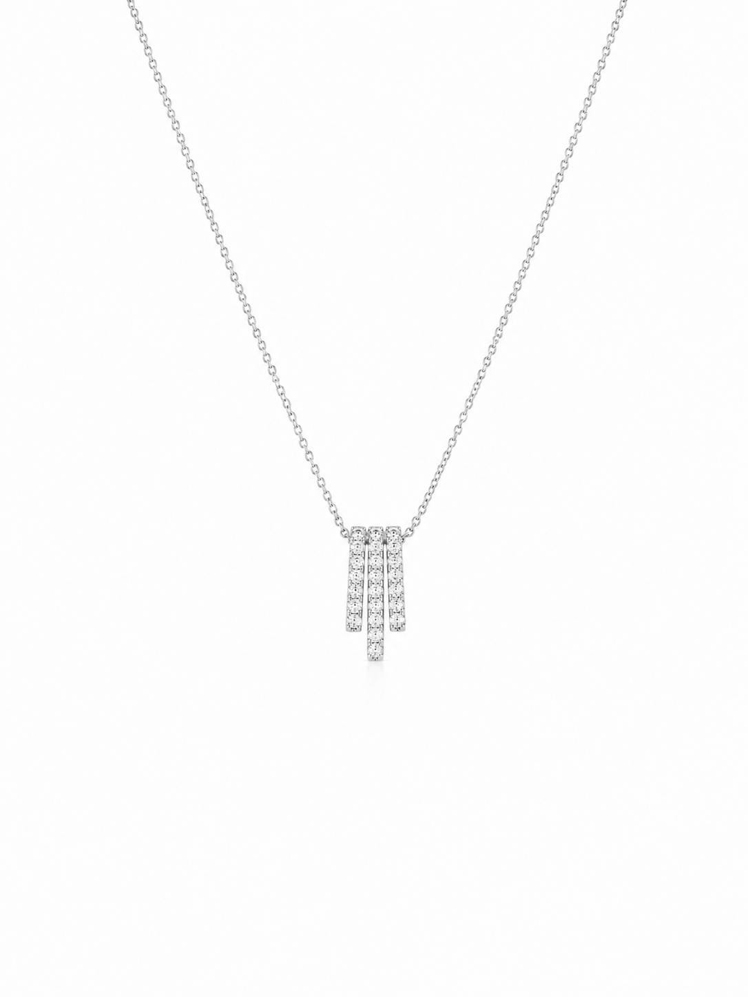 A delicate silver-toned chain necklace with a small geometric pendant set with clear stones, displayed against a solid white background.