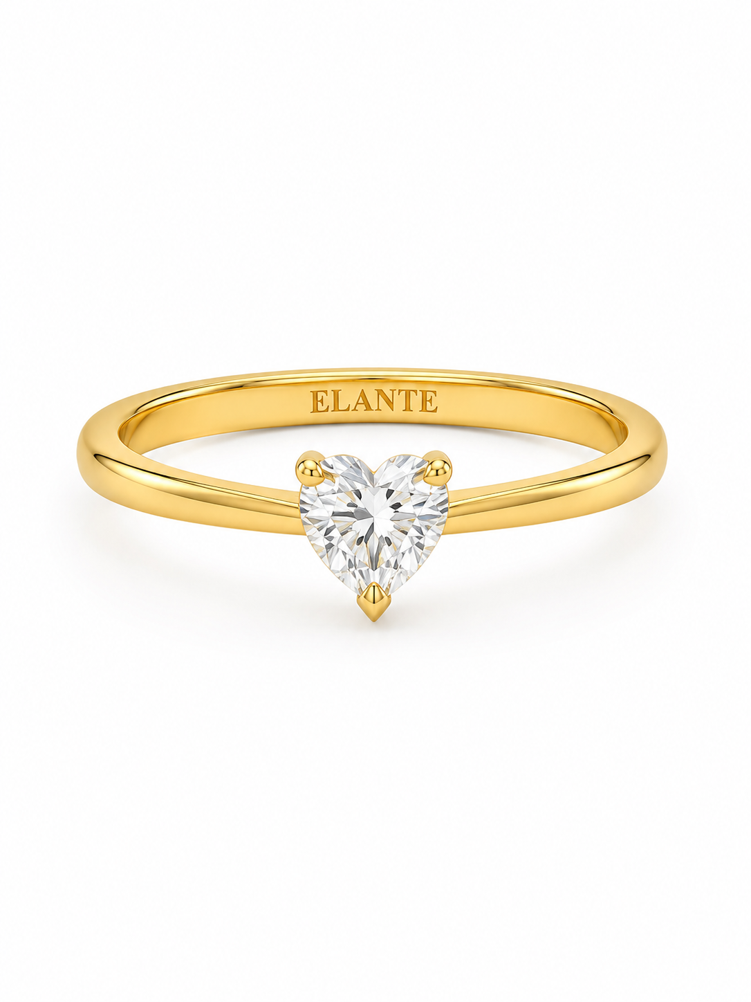A yellow gold solitaire engagement ring featuring a heart-shaped Lab diamond in a four-prong setting. The inner band of the ring is engraved with the brand name 'ELANTE'.