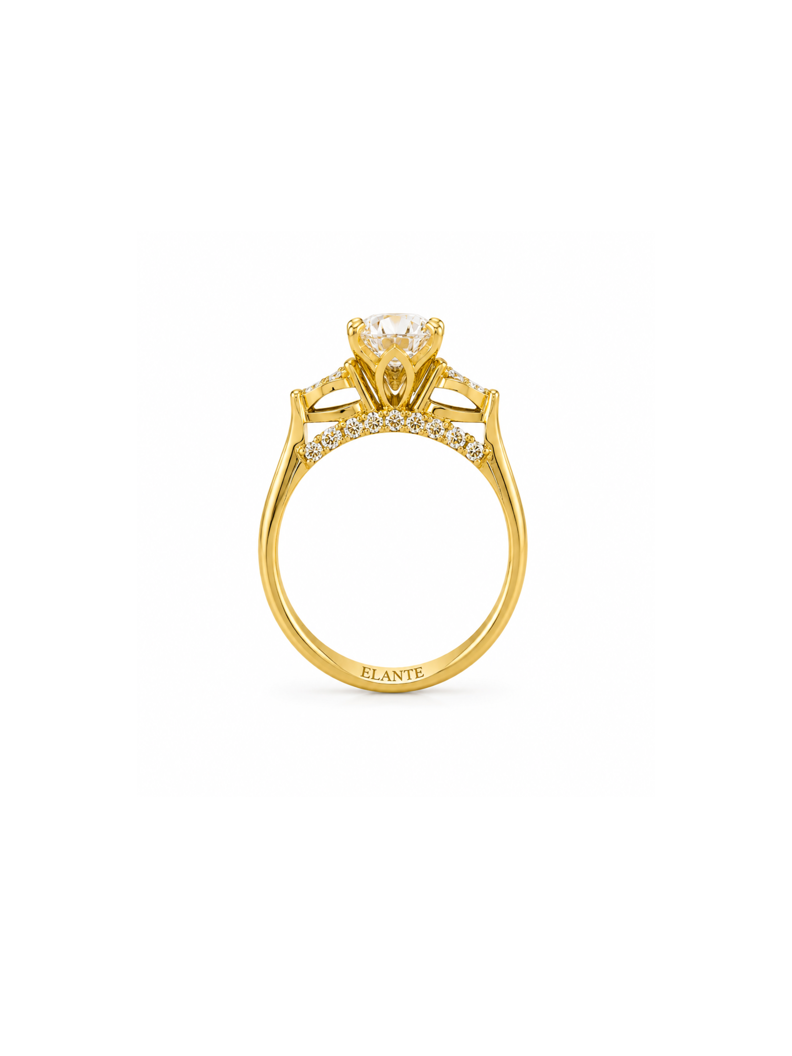 A yellow gold ring with a round-cut center stone and small pavé-set stones along the band, shown on a plain white background. The brand name elante is engraved on the inner band.