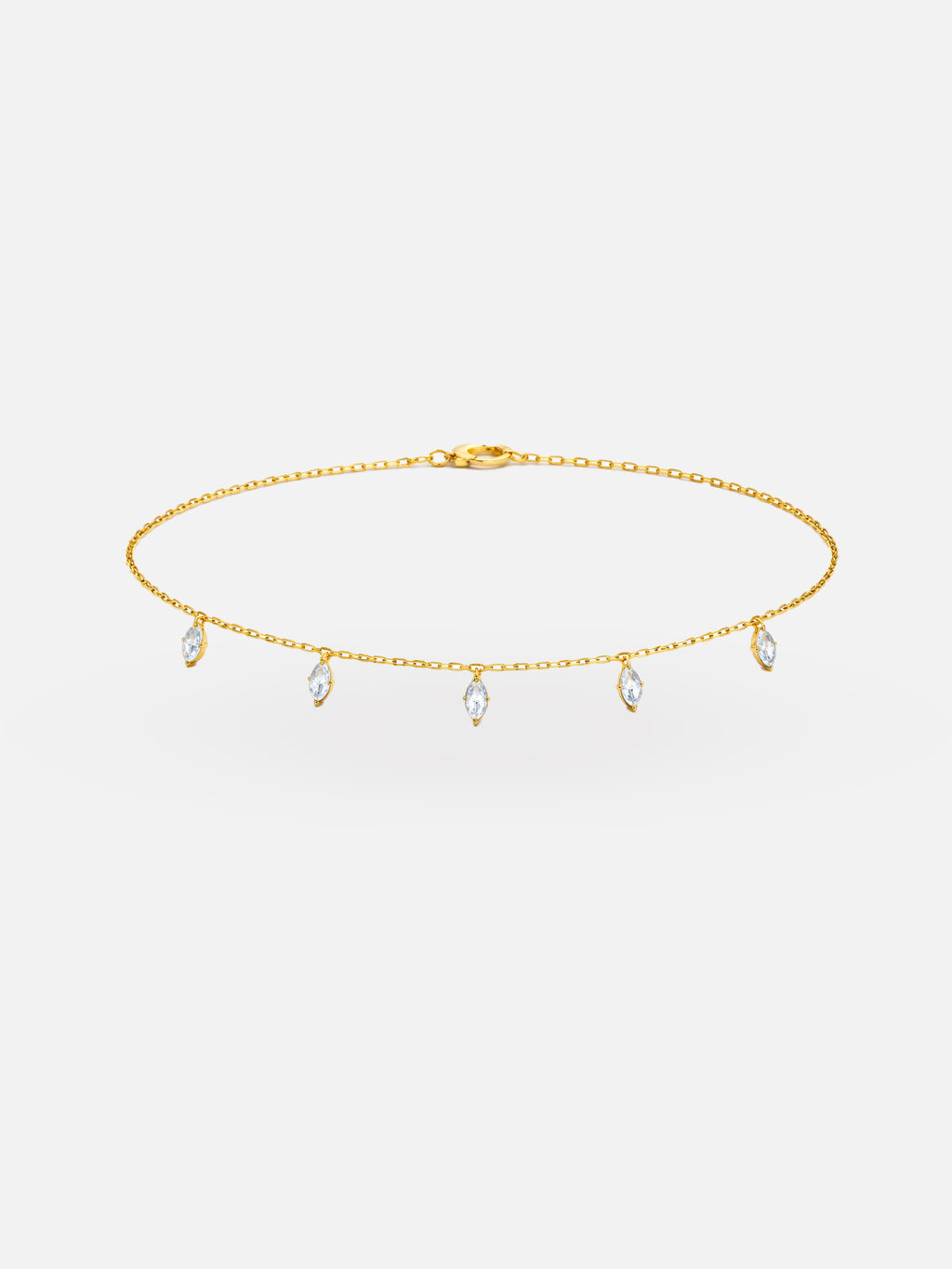 Gold choker necklace with small droplet-shaped pendants on a white background